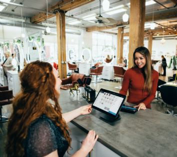 woman completing a transaction at a local business